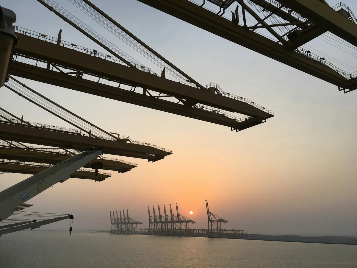 Container cranes at Jebel Ali Port at sunset, Dubai