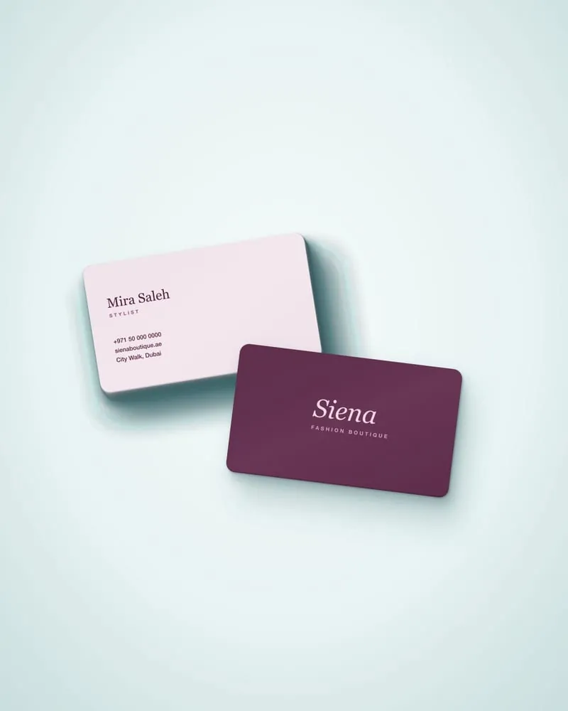 Premium embossed business cards with a gradient finish on a wooden table