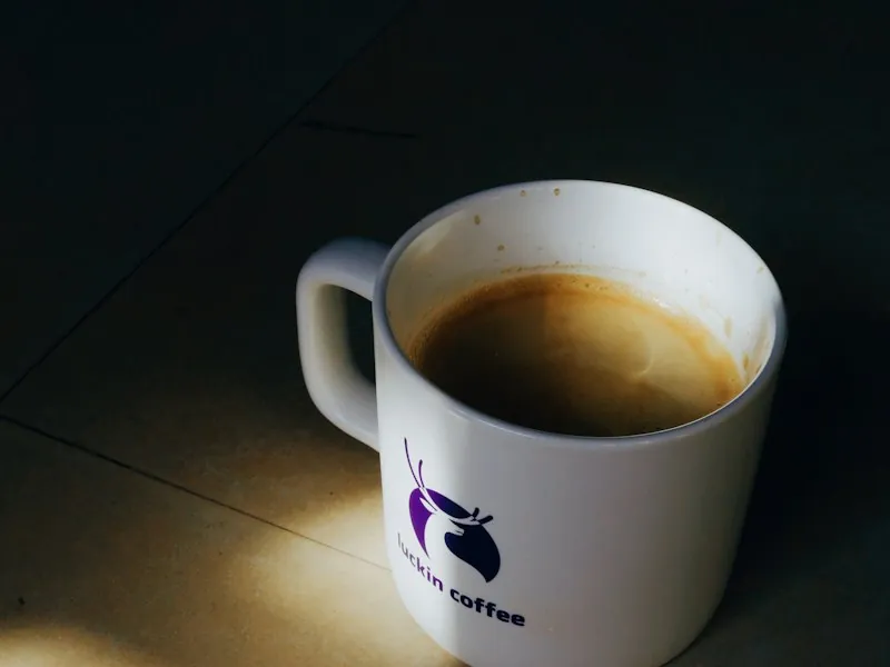 White coffee mug on a table in the sunlight
