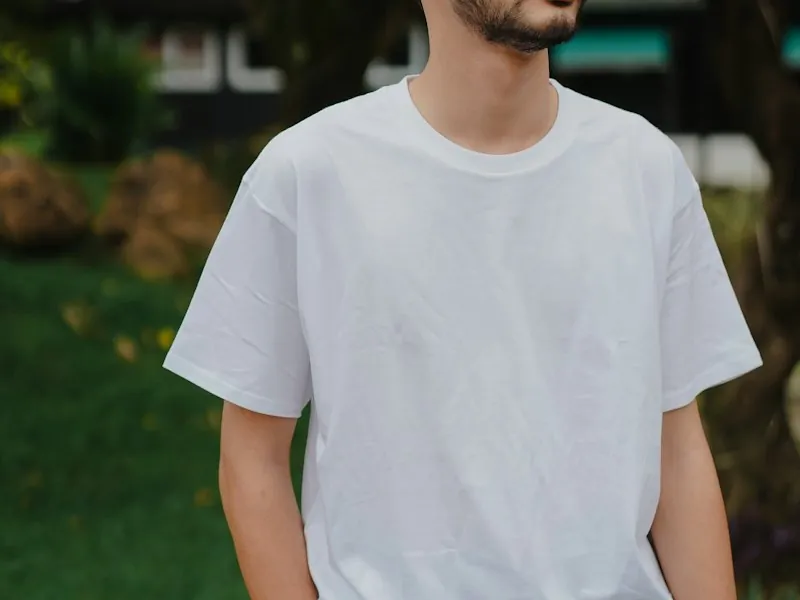 Person wearing a plain white T-shirt ready for printing