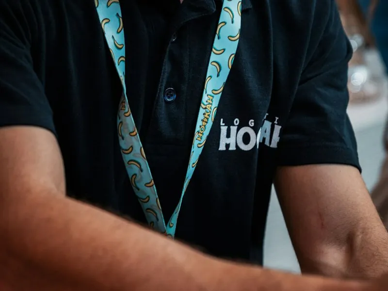 Staff member wearing a branded polo shirt and lanyard
