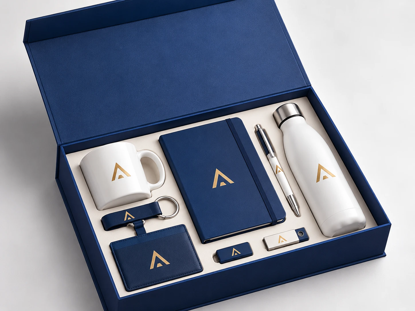 Navy branded corporate gift box with a logo mug, notebook, pen, bottle, keychain, card holder and USB drives